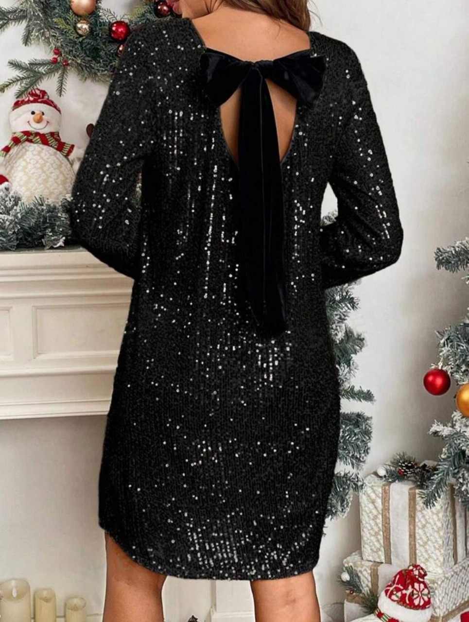 Zwarte glitterjurk met strik op de rug